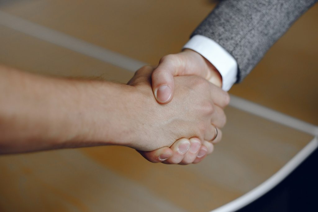 Close Up Image Of Firm Handshake Man Standing For Trusted Partnership